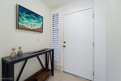 Entrance foyer featuring light tile patterned flooring and a textured ceiling