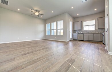 Kitchen featuring dishwasher, gray cabinetry, a c