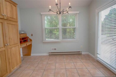 Breakfast area with tile floors. French door leads