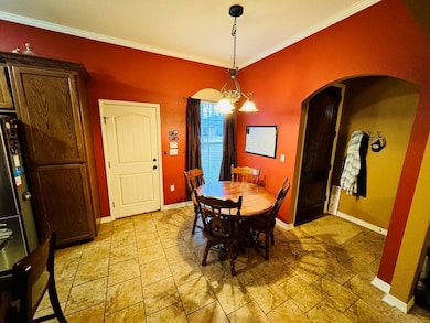 Dining room featuring crown molding and a chandeli