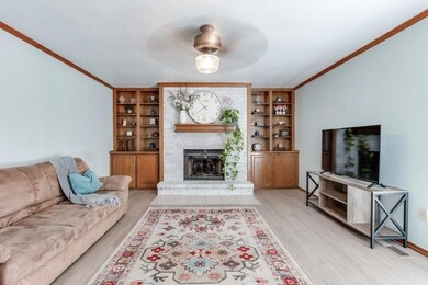 Living room with light wood-type flooring, crown m