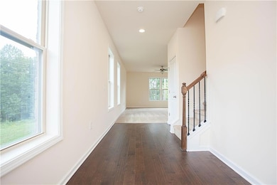 Hallway featuring stairway, dark wood-style floors, and recessed lighting
