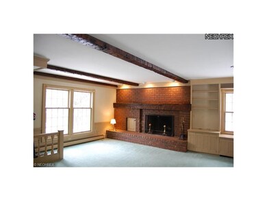 Raised hearth plenty of windows and custom bookshe