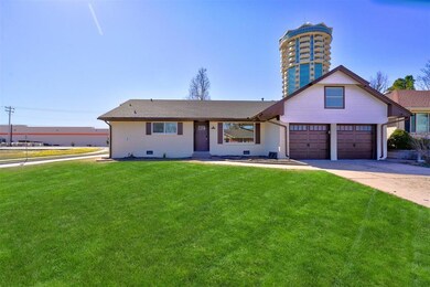 View of front of property with a garage, crawl spa