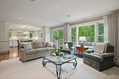 Serene family room off the kitchen with handsome built-ins and gas fireplace, and adjacent slider to oversized deck.