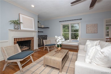 Living room with ornamental molding, a fireplace,