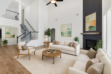Living area with a towering ceiling, arched walkw