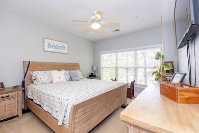 Bedroom featuring visible vents, ceiling fan, and light colored carpet