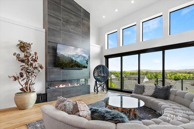 Living area featuring a tile fireplace, a high ceiling, wood finished floors, and recessed lighting