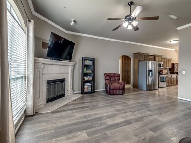 Living room with crown molding, plenty of natural 