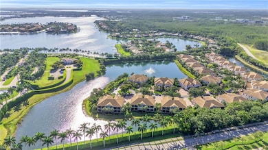 Birds eye view of property with a water view