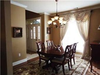 The spacious formal dining room offers wood floori