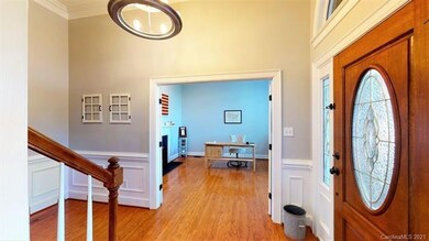Soaring ceilings with crown molding and wainscotin