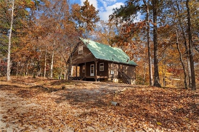 View of front of house featuring a large porch and a metal roof