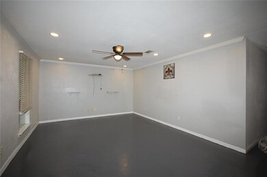 Living Room - concrete flooring, ceiling fan, and