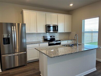 Kitchen with stainless steel appliances, dark woo