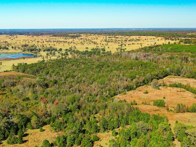 Aerial view of property and surrounding area featuring a nearby body of water