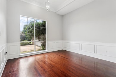 Another view of the dinning room the also features wainscoting.