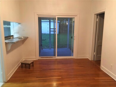 Opens into kitchen and onto a deck.