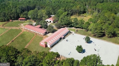 Main barn, indoor arena, and outdoor arena