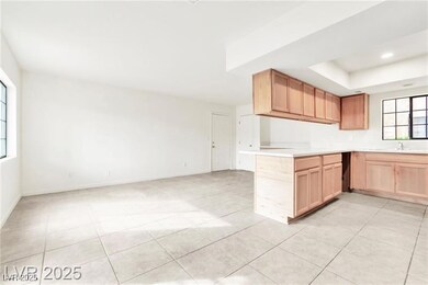 Kitchen featuring light countertops, open floor pl