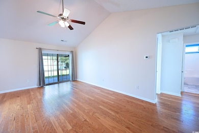 Unfurnished room with light wood finished floors, ceiling fan, and high vaulted ceiling