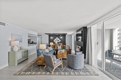 Living room featuring decorative columns and hardw