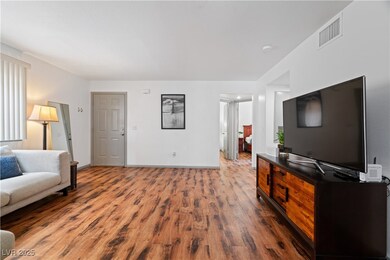 Living room featuring wood finished floors, basebo