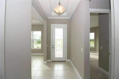 What a warm and inviting foyer entrance with a grand front door.