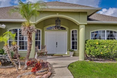 Covered Entry with Beautiful Landscaping