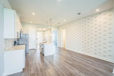Kitchen with a sink, light countertops, light woo
