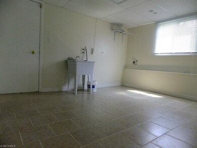 Off the laundry room with ceramic floor is a total