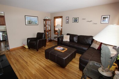 The spacious living room offers gorgeous hardwood 