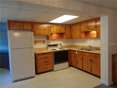 The kitchen features notty wood cabinets, and is open to the family room.