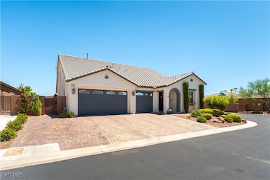Mediterranean / spanish-style home featuring a gate, decorative driveway, stucco siding, a garage, and a tiled roof