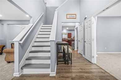 Stairway featuring wood finished floors, baseboard
