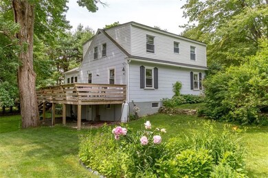 View of back yard, gardens, stone...