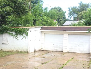Two car garage with ample storage area attached.