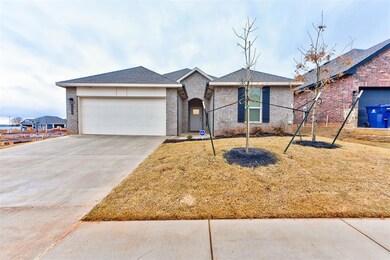 Ranch-style house with a garage and a front lawn