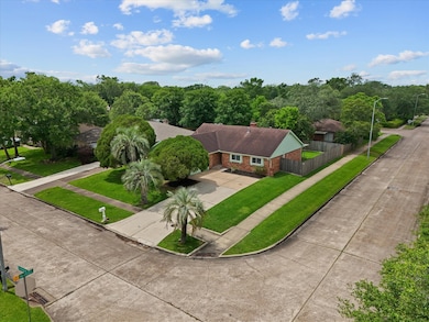 Ariel view of suburban home, mature trees, and yar