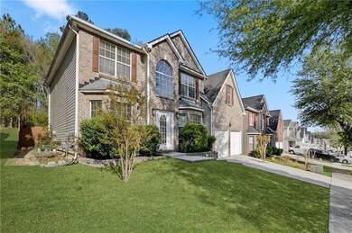 Traditional home featuring concrete driveway, a garage, a front yard, and a residential view