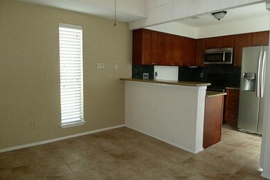 View of dining area and open kitchen with tile flo