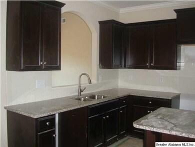 Large kitchen with subway tile, granite and an isl