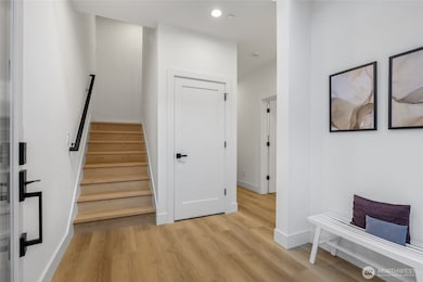 Foyer with vaulted ceiling and large coat & storage closet.