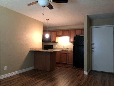 Kitchen featuring freestanding refrigerator, ceili