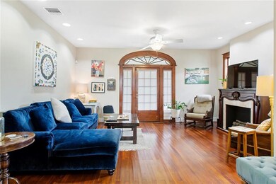 Light filled living space has original doors and w