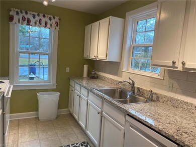 Light and airy kitchen with granite countertops and lots of windows