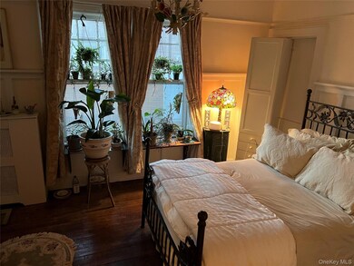 Bedroom with wood-type flooring