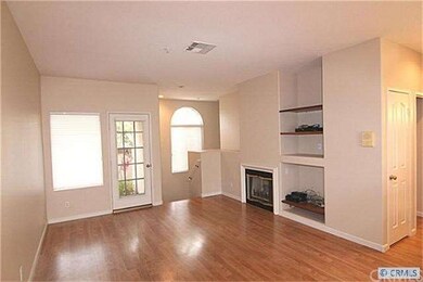 Living room w/ cozy fireplace and door to balcony