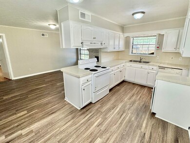 Kitchen featuring light wood-type flooring, white 